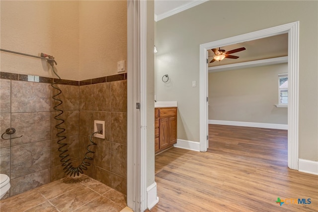 bathroom featuring hardwood / wood-style floors, vanity, crown molding, ceiling fan, and toilet