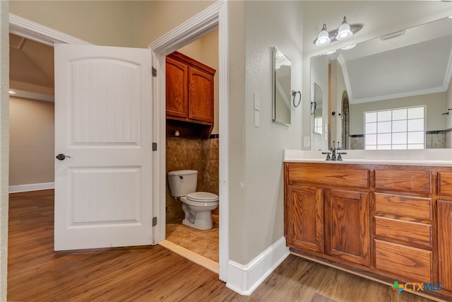 bathroom featuring crown molding, toilet, vanity, and hardwood / wood-style flooring