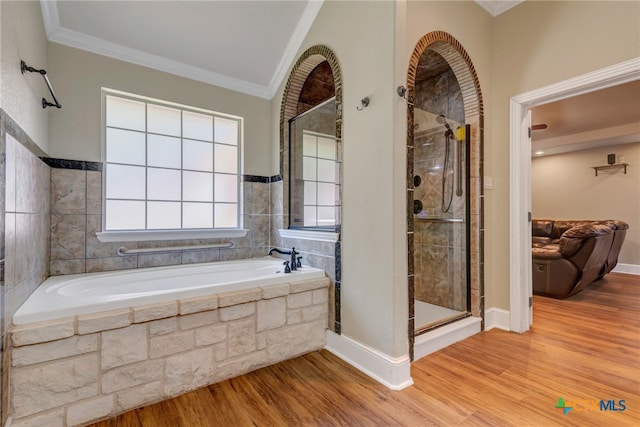 bathroom featuring independent shower and bath, ornamental molding, and hardwood / wood-style flooring