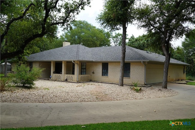 ranch-style home with a porch and a garage