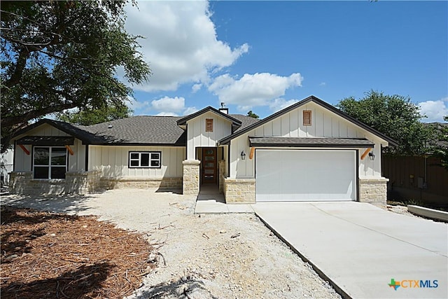 1560 Yaupon Dr, Fischer, TX 78623 - modern farmhouse style home with a garage, a shingled roof, driveway, and board and batten siding