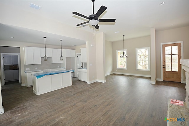 1560 Yaupon Dr, Fischer, TX 78623 - kitchen with white cabinets, open floor plan, ceiling fan, and dark wood-style floors