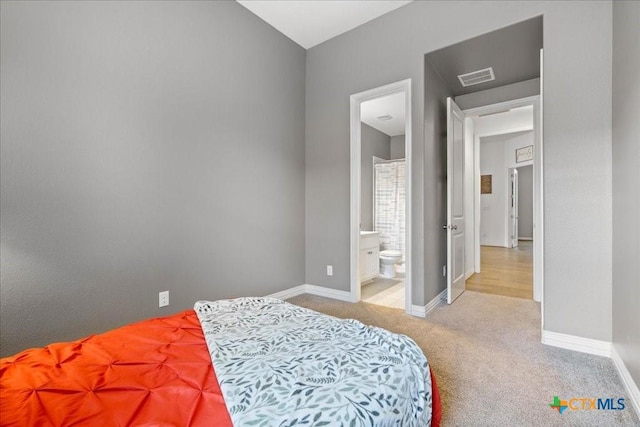 bedroom featuring visible vents, baseboards, carpet floors, and ensuite bathroom