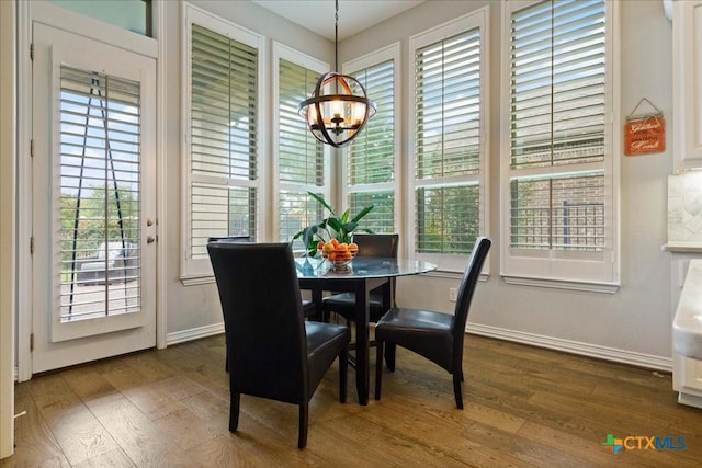 dining room with baseboards, dark wood-style flooring, and a notable chandelier