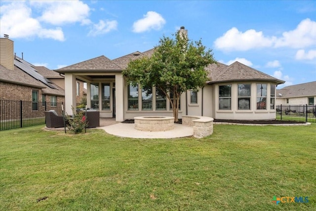back of house featuring a fire pit, fence, stucco siding, a patio area, and a yard