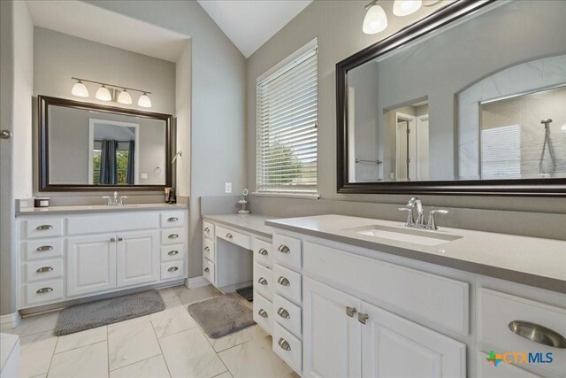 full bath featuring a sink, two vanities, lofted ceiling, and marble finish floor