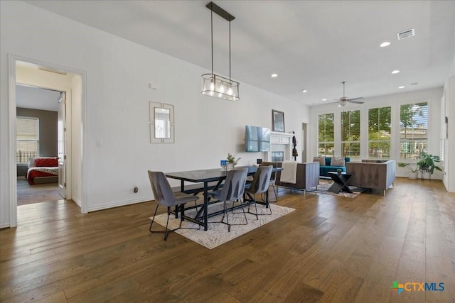 dining room featuring wood-type flooring, a ceiling fan, visible vents, and recessed lighting