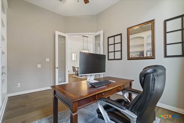 office with a ceiling fan, baseboards, and dark wood finished floors