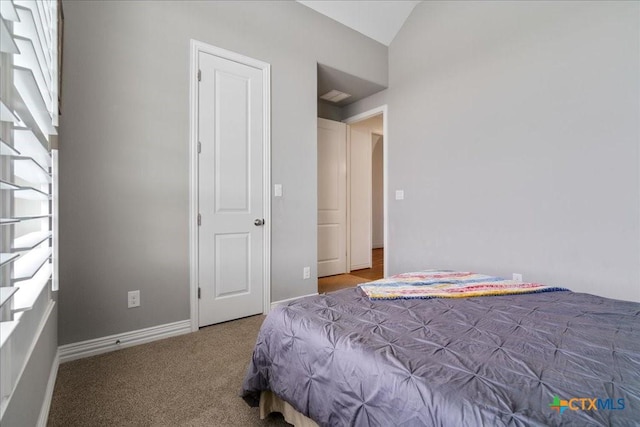 carpeted bedroom featuring arched walkways, baseboards, and lofted ceiling