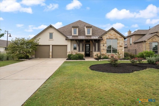 view of front of property with a front lawn, stone siding, stucco siding, a standing seam roof, and driveway
