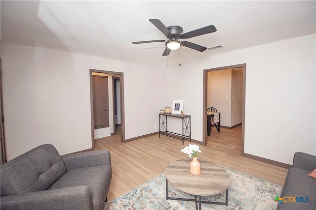 1317 N 10th St, Temple, TX 76501 - living room with light wood finished floors, ceiling fan, and baseboards