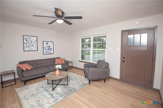 1317 N 10th St, Temple, TX 76501 - living area featuring light wood-style flooring, ceiling fan, and baseboards