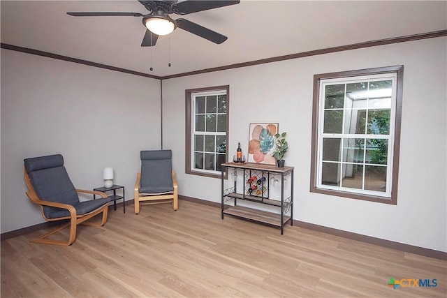 1317 N 10th St, Temple, TX 76501 - sitting room with light wood finished floors, baseboards, crown molding, and ceiling fan