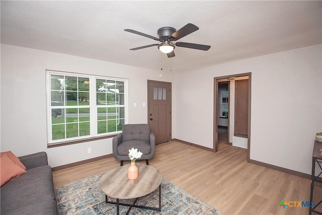 1317 N 10th St, Temple, TX 76501 - living area featuring light wood-style floors, a ceiling fan, and baseboards