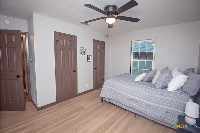 1317 N 10th St, Temple, TX 76501 - bedroom with light wood-style flooring, baseboards, and a ceiling fan