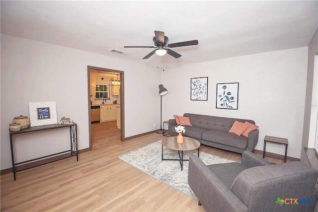 1317 N 10th St, Temple, TX 76501 - living area featuring light wood-style flooring, a ceiling fan, and baseboards