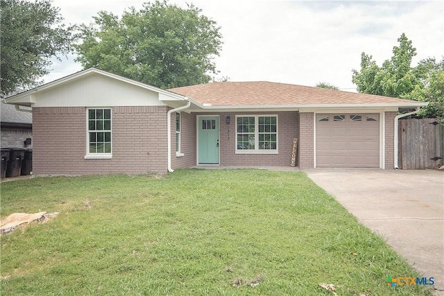 1317 N 10th St, Temple, TX 76501 - ranch-style house featuring a garage, driveway, brick siding, and roof with shingles