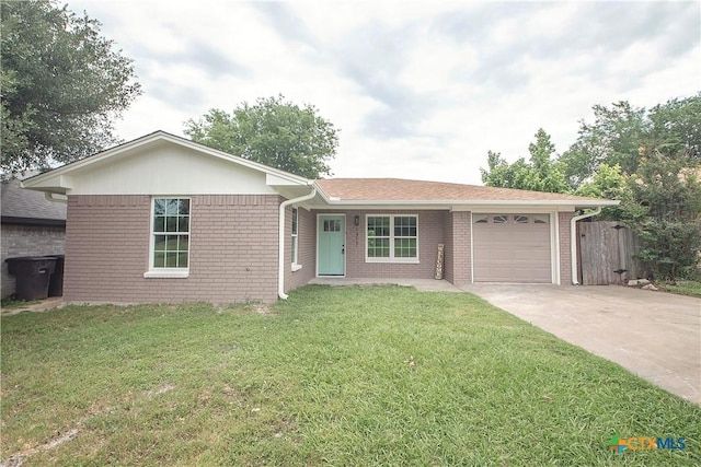 1317 N 10th St, Temple, TX 76501 - ranch-style house with brick siding, concrete driveway, and an attached garage