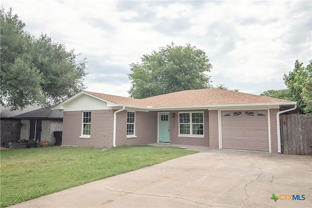 1317 N 10th St, Temple, TX 76501 - single story home featuring a garage, concrete driveway, brick siding, and roof with shingles