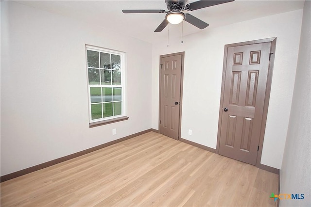 1317 N 10th St, Temple, TX 76501 - unfurnished bedroom with light wood-type flooring, baseboards, and a ceiling fan