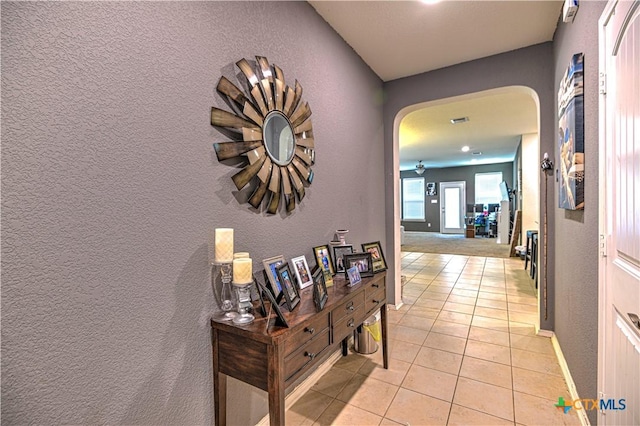 9006 Single Bend Trl, Temple, TX 76502 - hallway with arched walkways, light tile patterned flooring, and a textured wall