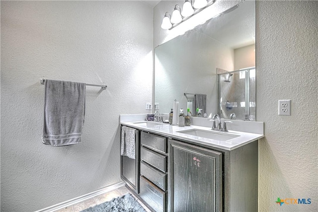 9006 Single Bend Trl, Temple, TX 76502 - bathroom featuring double vanity, a stall shower, and a textured wall
