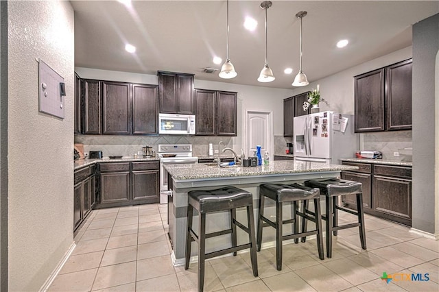 9006 Single Bend Trl, Temple, TX 76502 - kitchen with white appliances, backsplash, light tile patterned flooring, dark brown cabinets, and recessed lighting