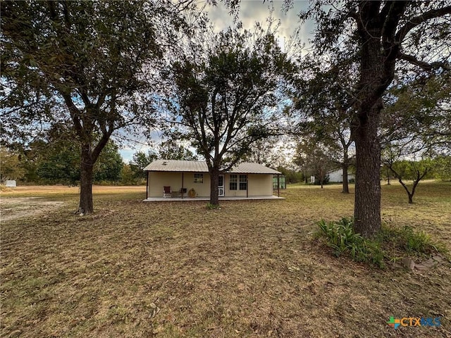 view of front of property with a front yard and metal roof