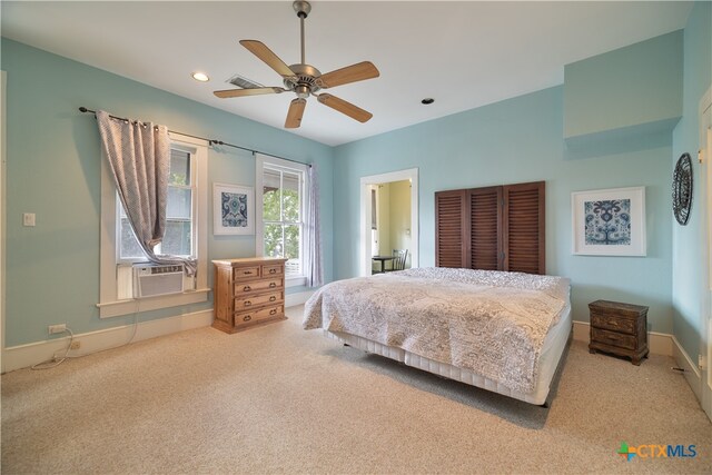 carpeted bedroom with ceiling fan and cooling unit