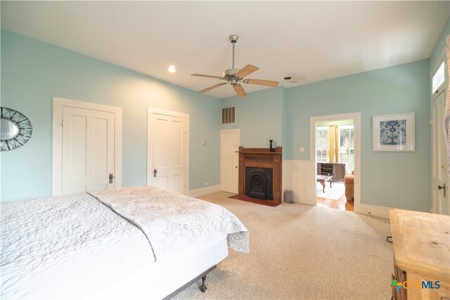 bedroom featuring ceiling fan and light colored carpet