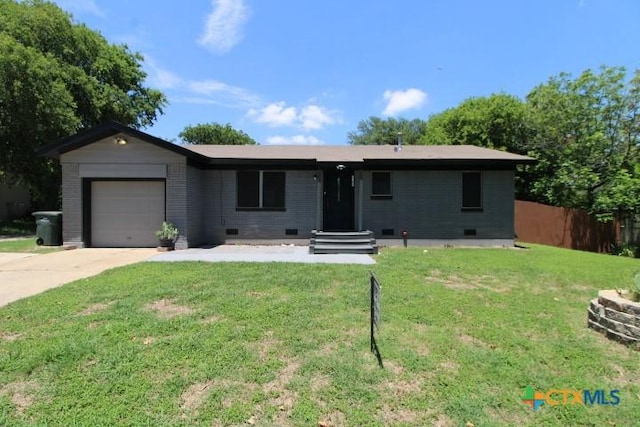 ranch-style house with a garage and a front lawn