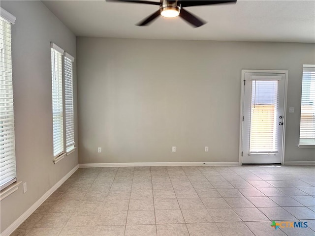 137 Rustic Glen Dr, San Marcos, TX 78666 - spare room featuring ceiling fan, plenty of natural light, light tile patterned floors, and baseboards