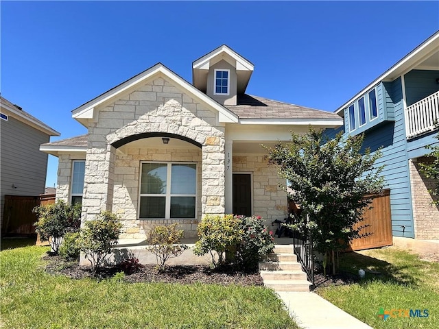 137 Rustic Glen Dr, San Marcos, TX 78666 - view of front of house with stone siding, covered porch, and roof with shingles