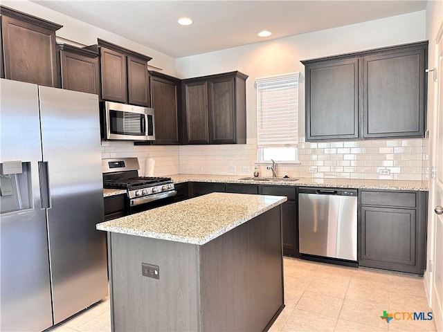 137 Rustic Glen Dr, San Marcos, TX 78666 - kitchen with appliances with stainless steel finishes, a sink, light tile patterned floors, light stone counters, and dark brown cabinets