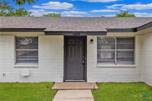 1008 Ronstan Dr, Killeen, TX 76542 - property entrance featuring roof with shingles and brick siding