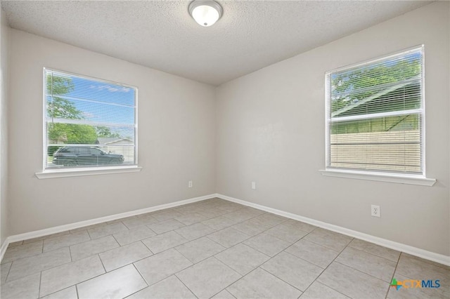 1008 Ronstan Dr, Killeen, TX 76542 - unfurnished room featuring a textured ceiling, light tile patterned floors, and baseboards