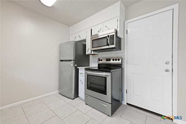 1008 Ronstan Dr, Killeen, TX 76542 - kitchen featuring appliances with stainless steel finishes, a textured ceiling, white cabinets, baseboards, and tasteful backsplash