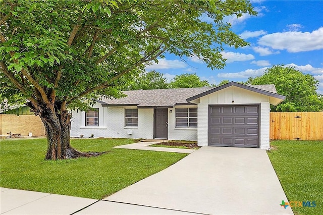 1008 Ronstan Dr, Killeen, TX 76542 - ranch-style home featuring an attached garage, brick siding, driveway, roof with shingles, and board and batten siding