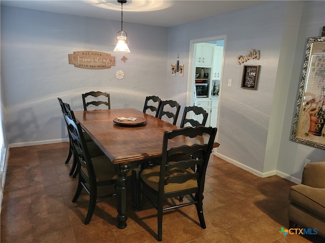 dining area featuring dark tile patterned flooring