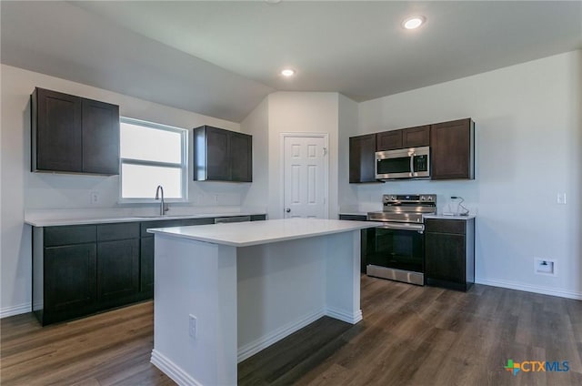 3820 Poteet Ct, Temple, TX 76504 - kitchen featuring light countertops, a sink, a center island, appliances with stainless steel finishes, and dark wood-style flooring