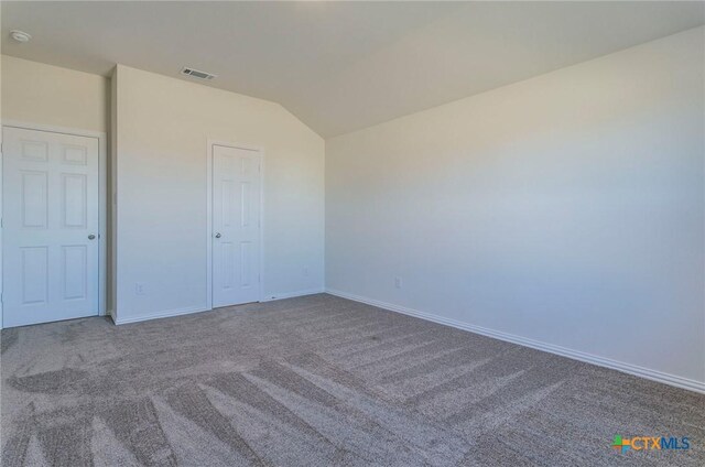 3820 Poteet Ct, Temple, TX 76504 - unfurnished bedroom featuring baseboards, vaulted ceiling, visible vents, and carpet