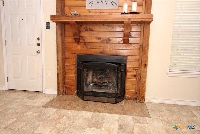 interior details featuring baseboards and a fireplace