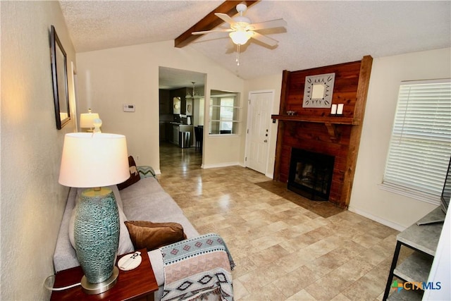 living room with a brick fireplace, vaulted ceiling with beams, ceiling fan, and baseboards