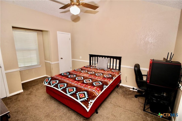 carpeted bedroom featuring baseboards, a textured ceiling, and ceiling fan