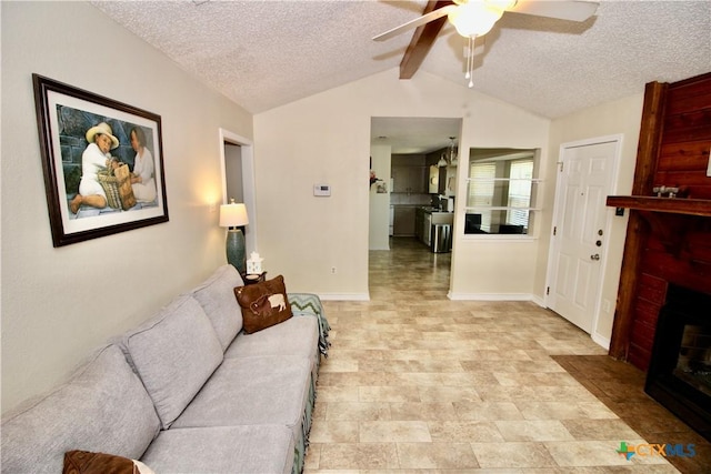 living area with ceiling fan, lofted ceiling with beams, a fireplace, a textured ceiling, and baseboards