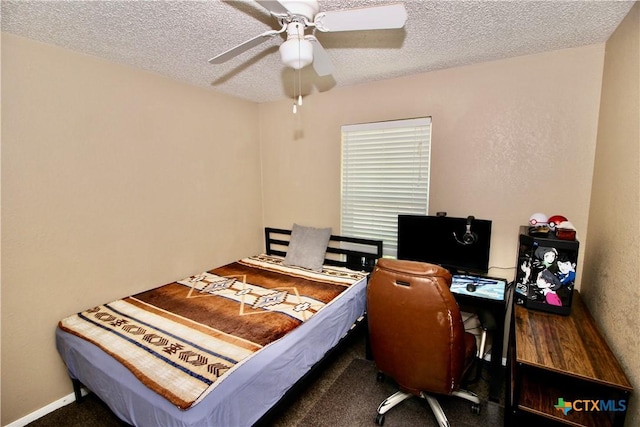 bedroom featuring carpet, a ceiling fan, and a textured ceiling