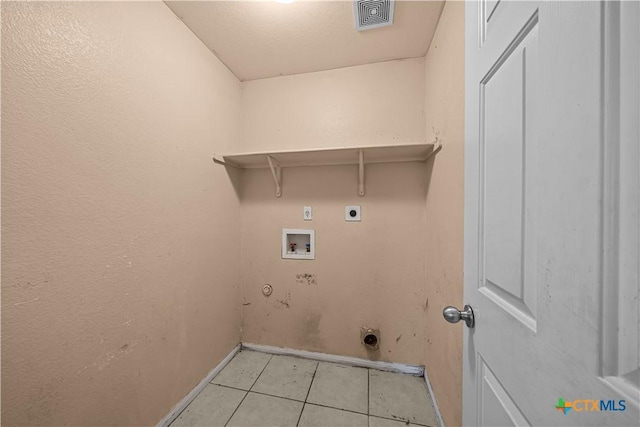 washroom featuring hookup for an electric dryer, washer hookup, gas dryer hookup, and light tile patterned flooring