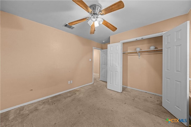 unfurnished bedroom with ceiling fan, light carpet, and a closet