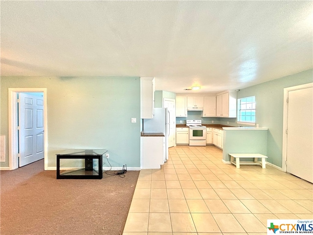 kitchen featuring white cabinetry, white appliances, a textured ceiling, and light carpet