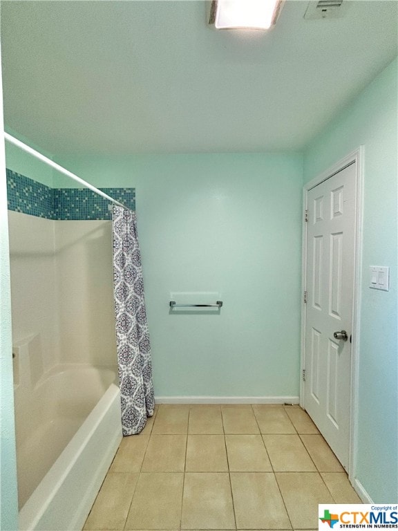 bathroom with tile patterned flooring and shower / bath combo